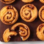 Pecan rolls on a wood board.