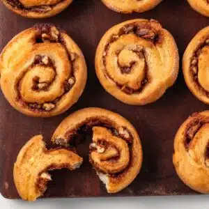 Pecan rolls on a wood board.