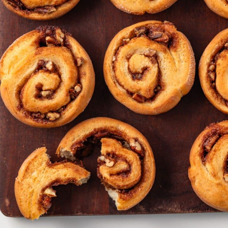 Pecan rolls on a wood board.
