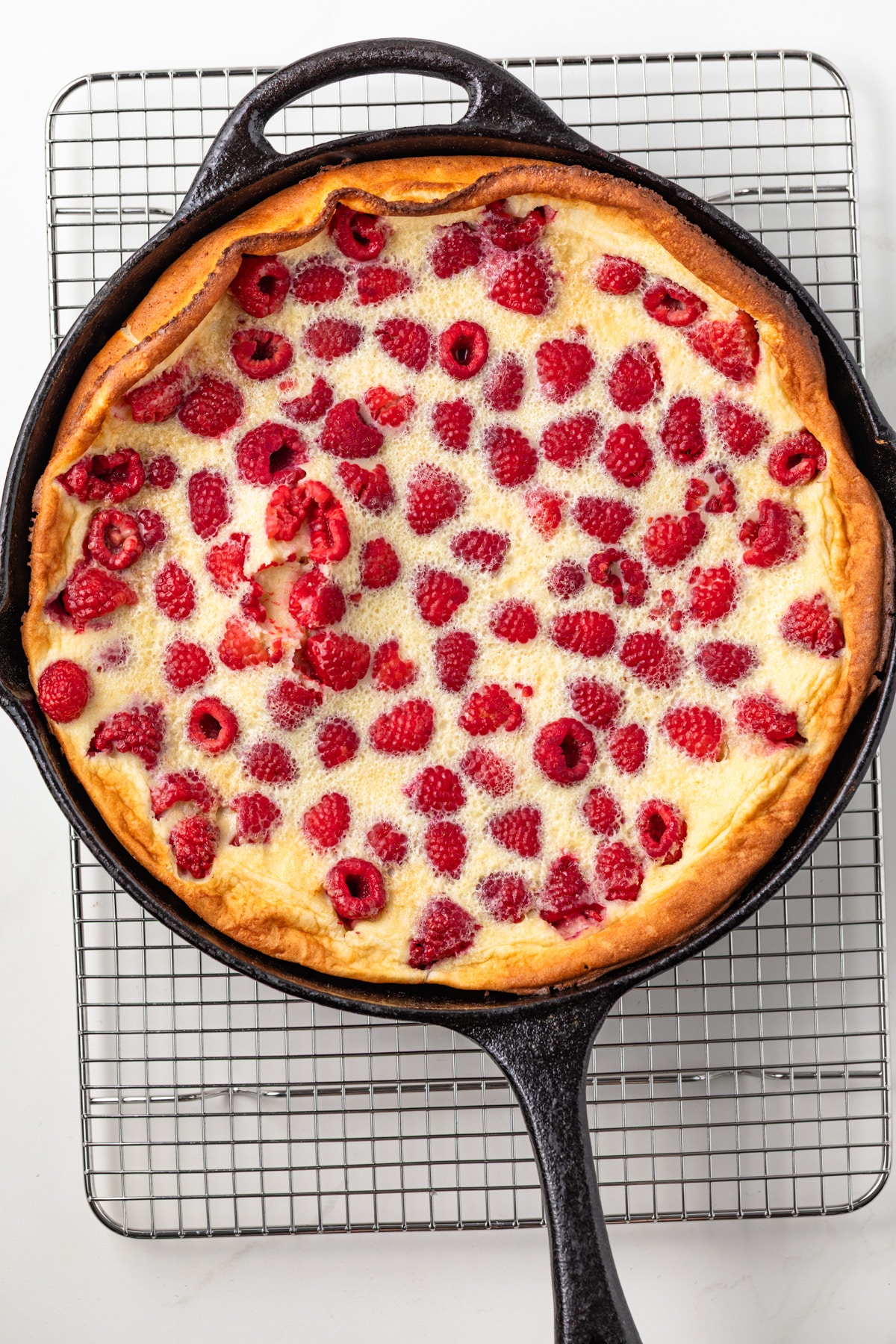 Baked clafoutis in a cast iron skillet.