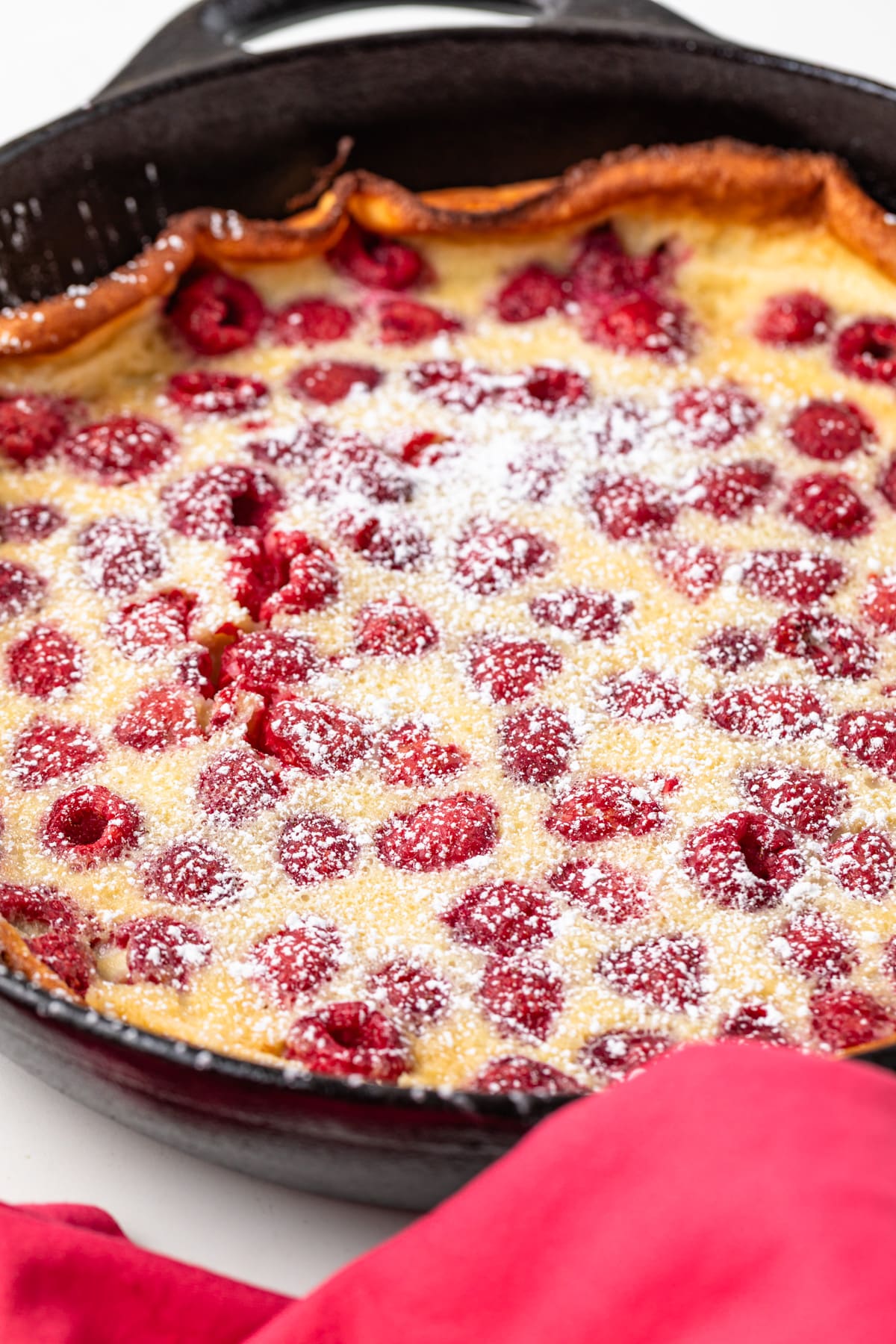 Angled view of raspberry almond clafoutis.