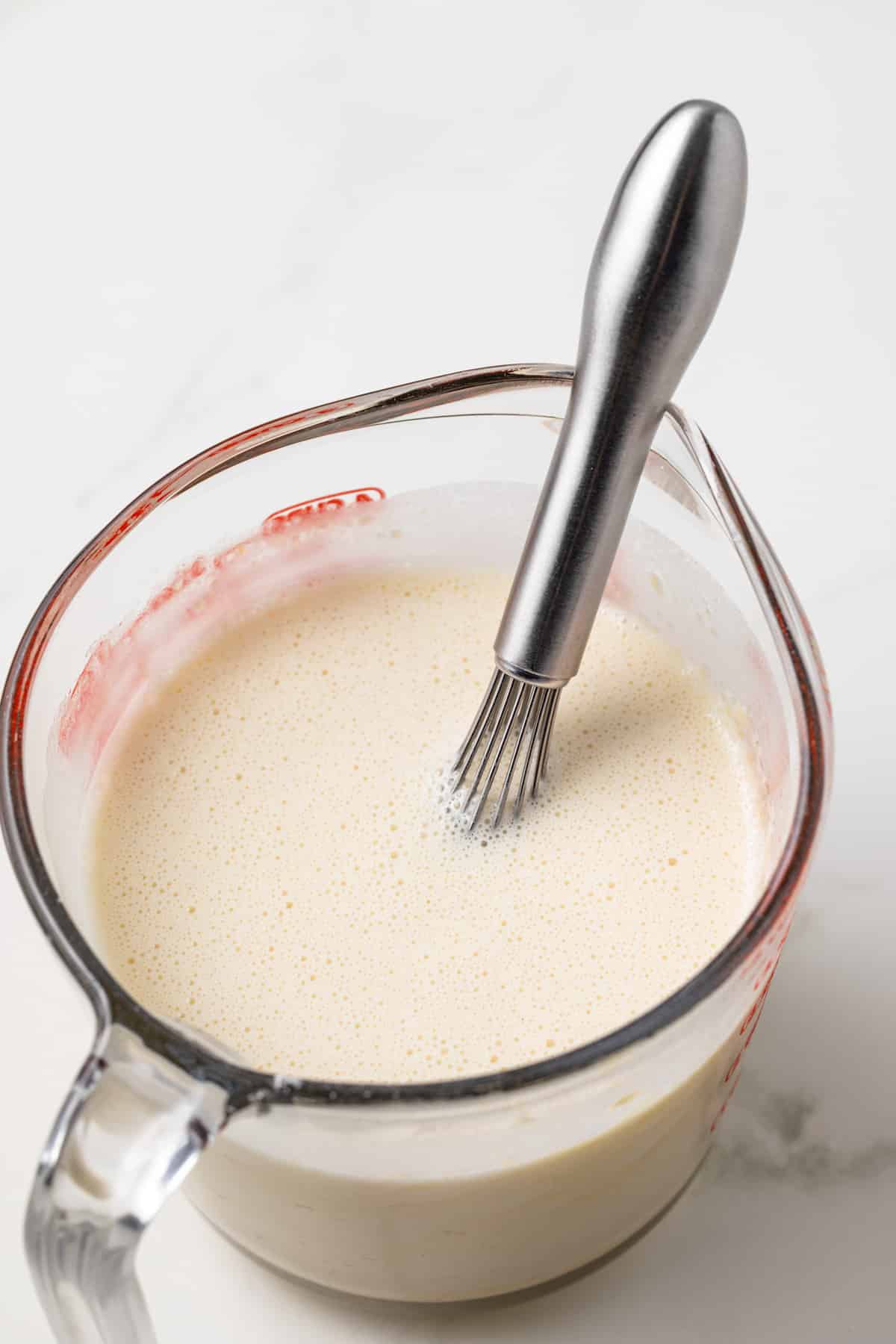 Custard base in a glass measuring cup.