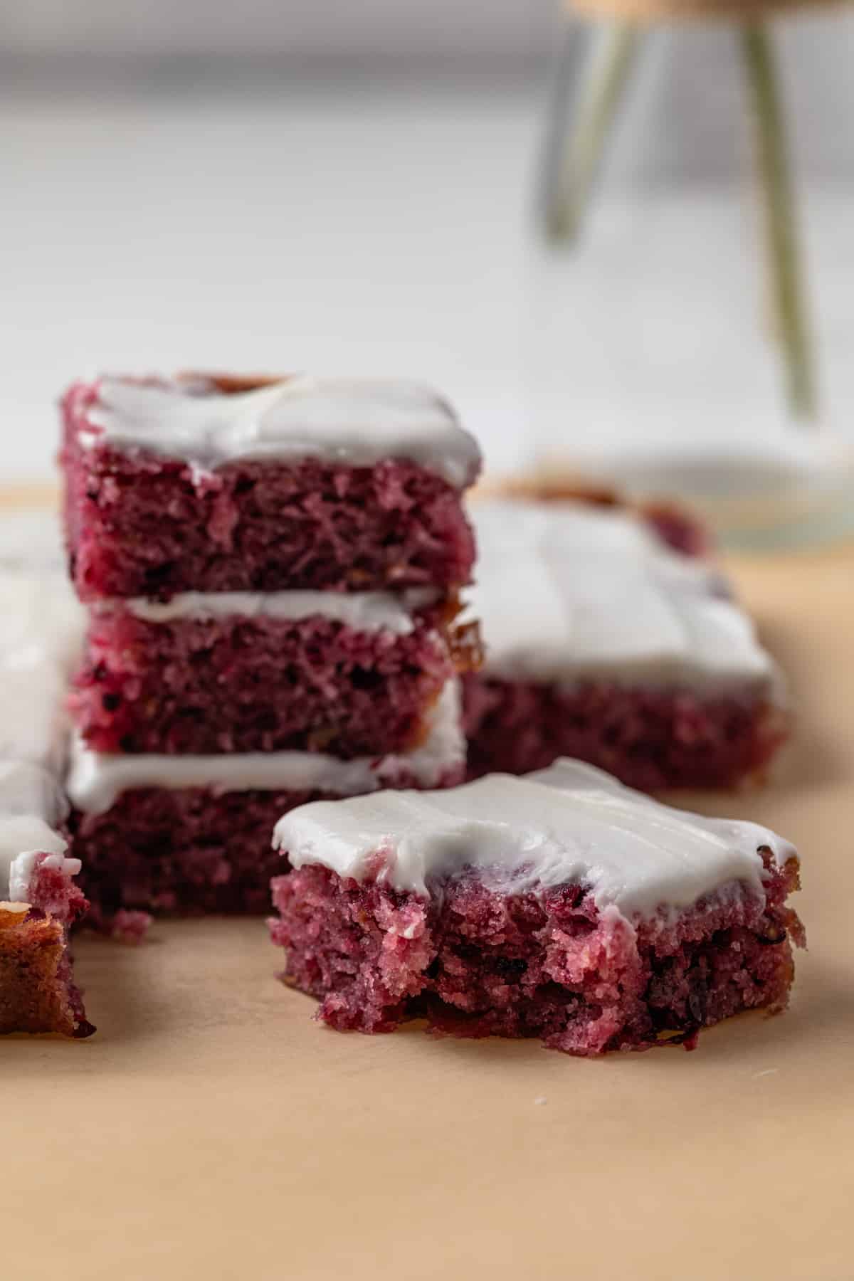 Blackberry lemon bars with a bite taken out of one.