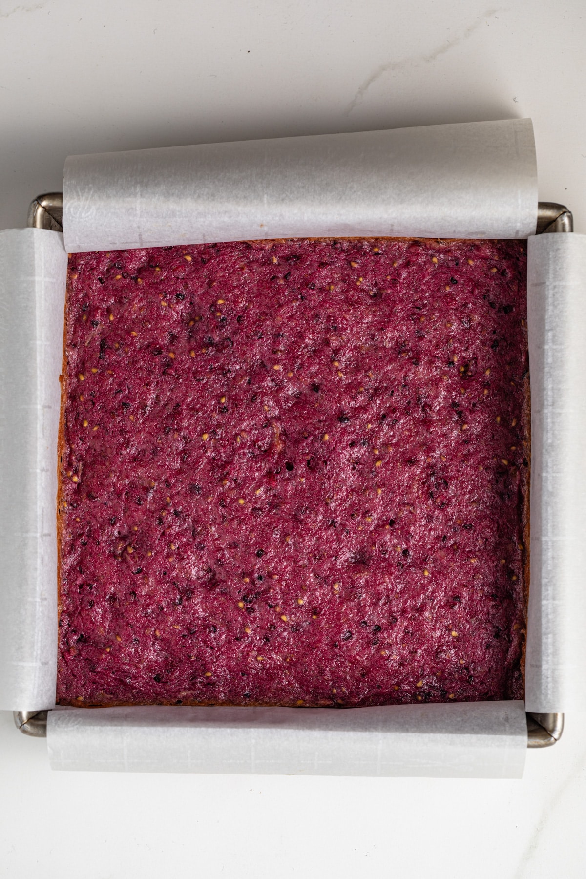 Baked blackberry lemon bars in a square pan.