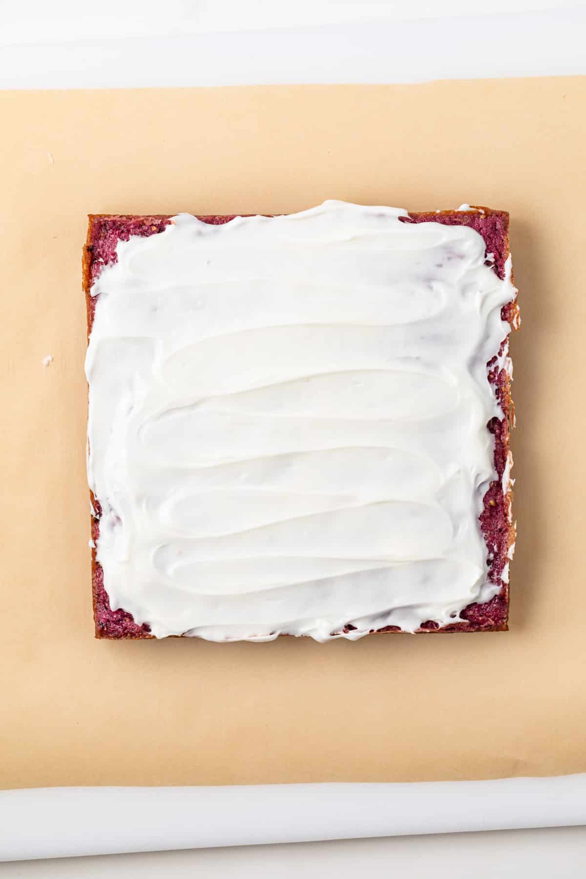 Blackberry lemon bars covered in icing.