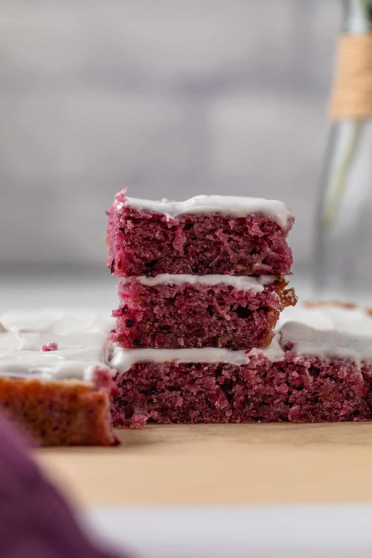 Blackberry lemon bars stacked three high.