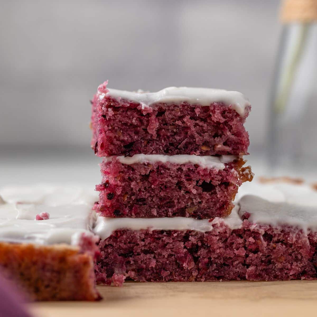 Blackberry lemon bars stacked three high.