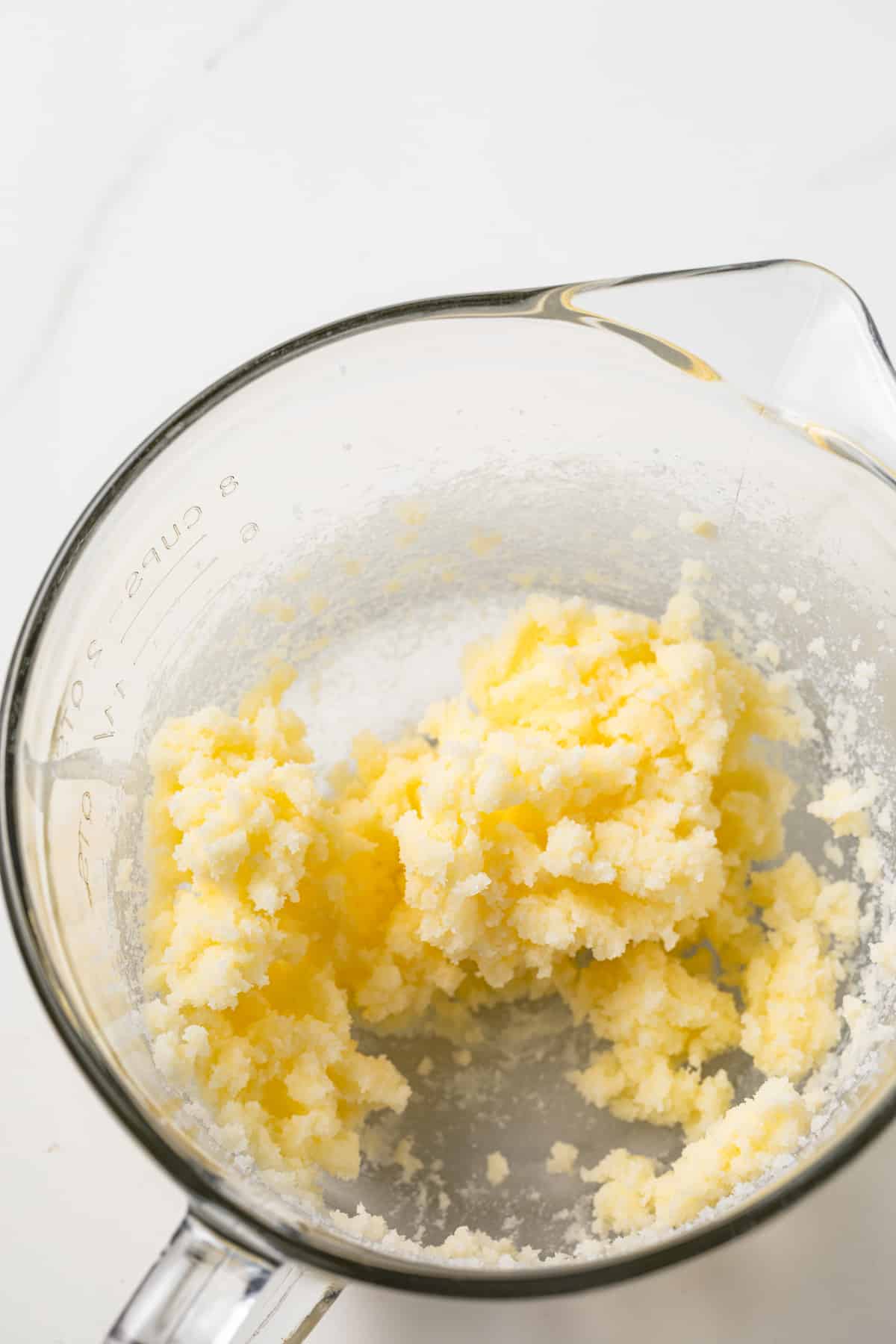 Creamed butter and sugar in a glass bowl.