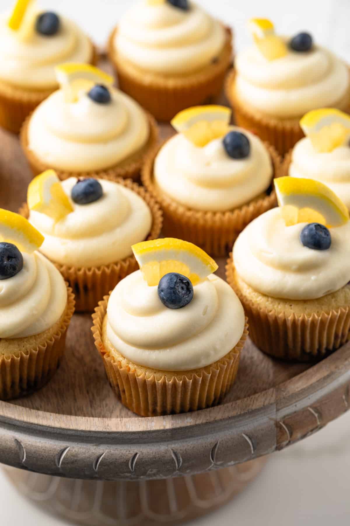 Close up of lemon blueberry cupcakes on a cake stand.