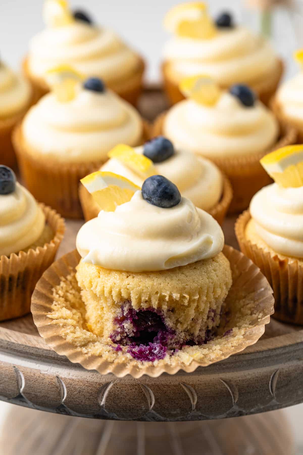 Lemon blueberry cupcake with the wrapper peeled away.