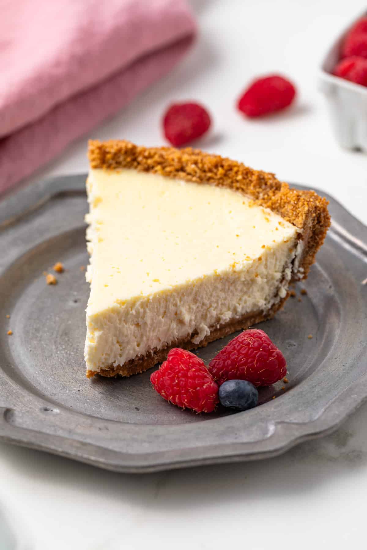 Slice of cheesecake pie on a silver plate.