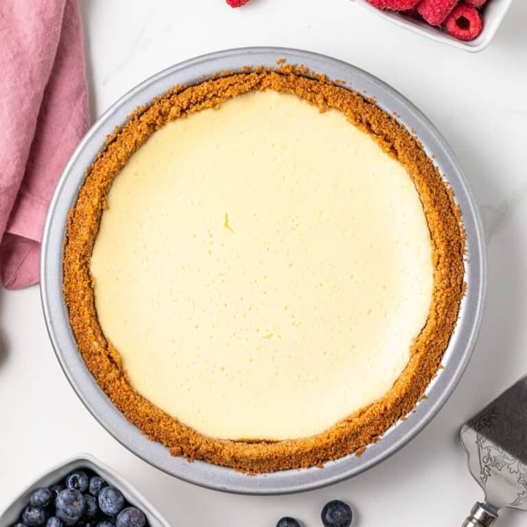 Overhead of cheesecake pie in metal pie plate.