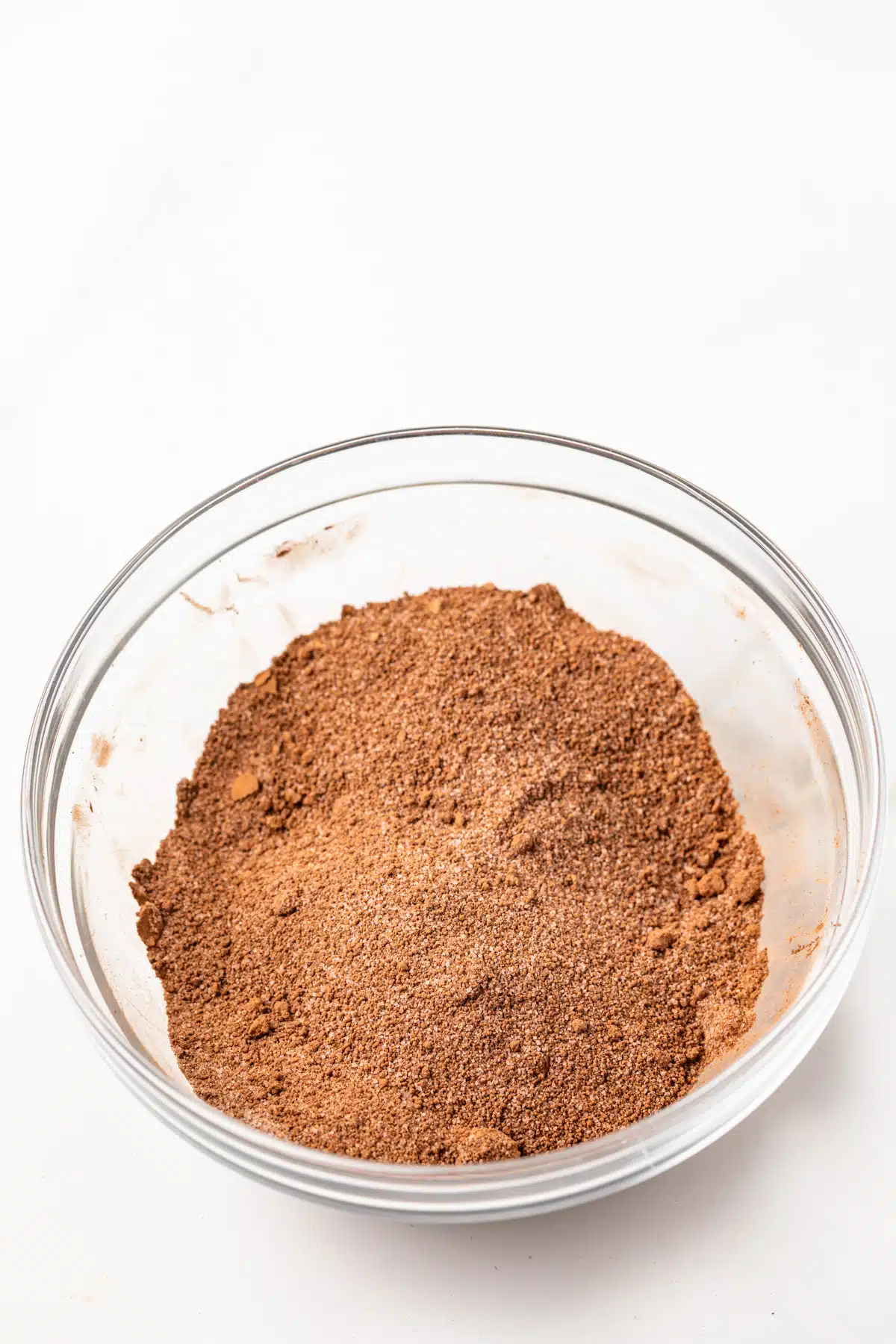 A mixture of cocoa powder and sugar in a glass bowl.