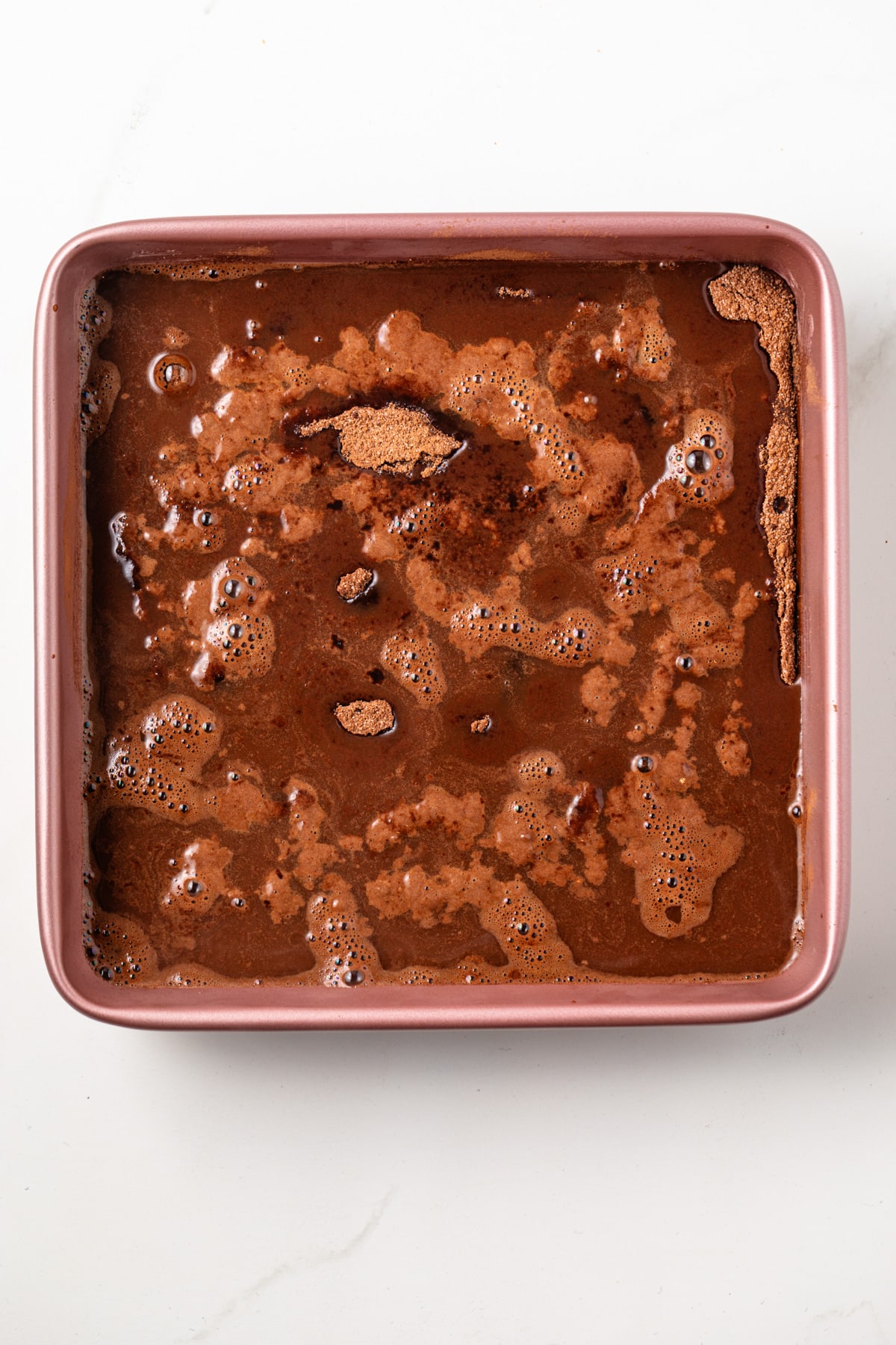 Water over the batter in a square baking dish.