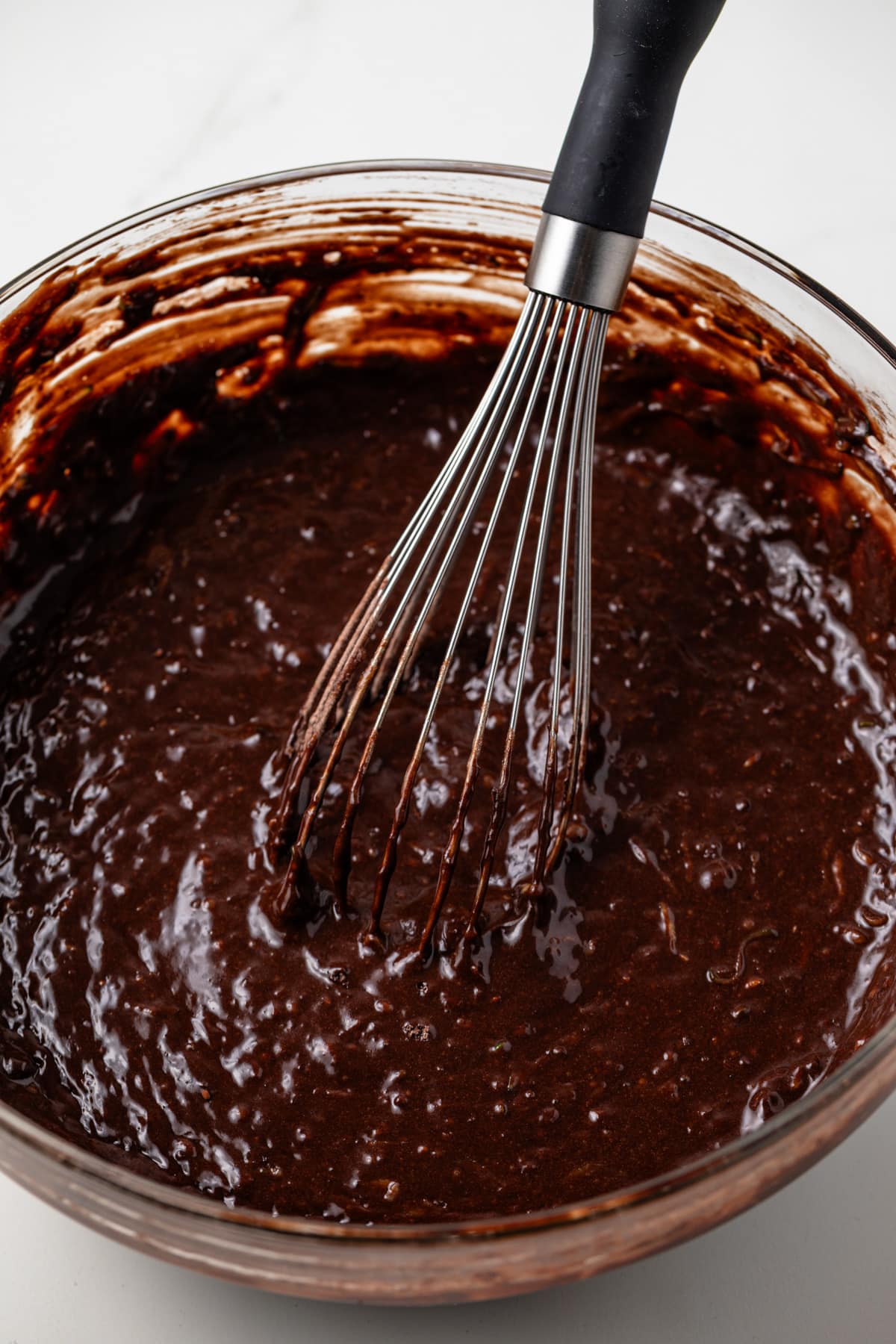 Chocolate zucchini cupcake batter in a glass bowl.